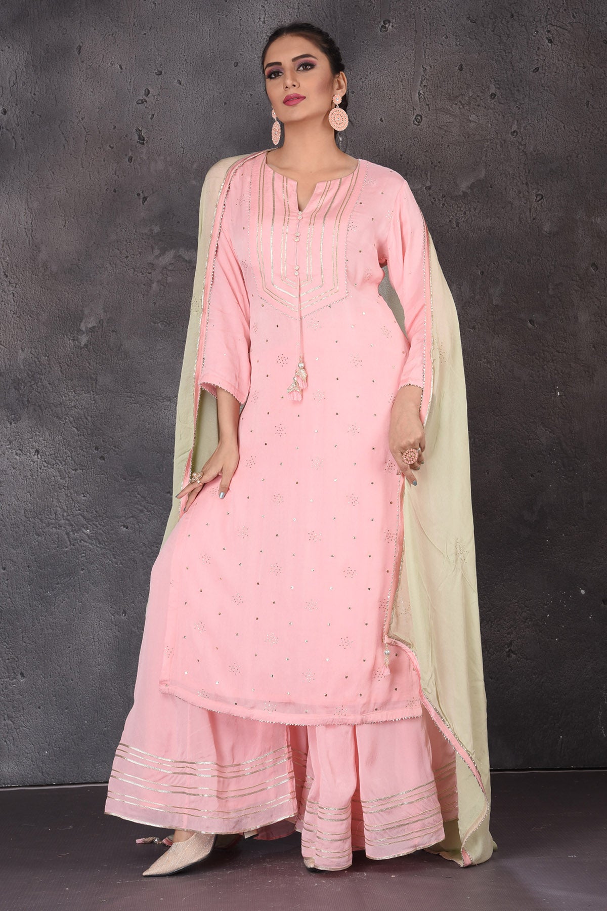 Shop stunning pastel pink gota work palazzo suit online in USA with pastel green dupatta. Look elegant at weddings and festive occasions in exclusive designer suits, designer gowns, Anarkali suits, sharara suits, wedding gowns, palazzo suits, designer lehenga from Pure Elegance Indian clothing store in USA.-front