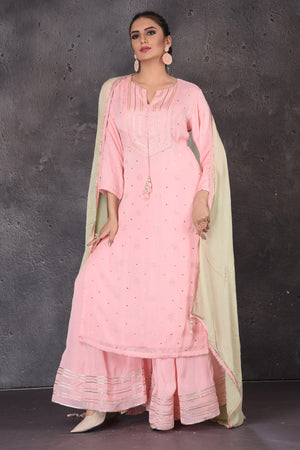 Shop stunning pastel pink gota work palazzo suit online in USA with pastel green dupatta. Look elegant at weddings and festive occasions in exclusive designer suits, designer gowns, Anarkali suits, sharara suits, wedding gowns, palazzo suits, designer lehenga from Pure Elegance Indian clothing store in USA.-front