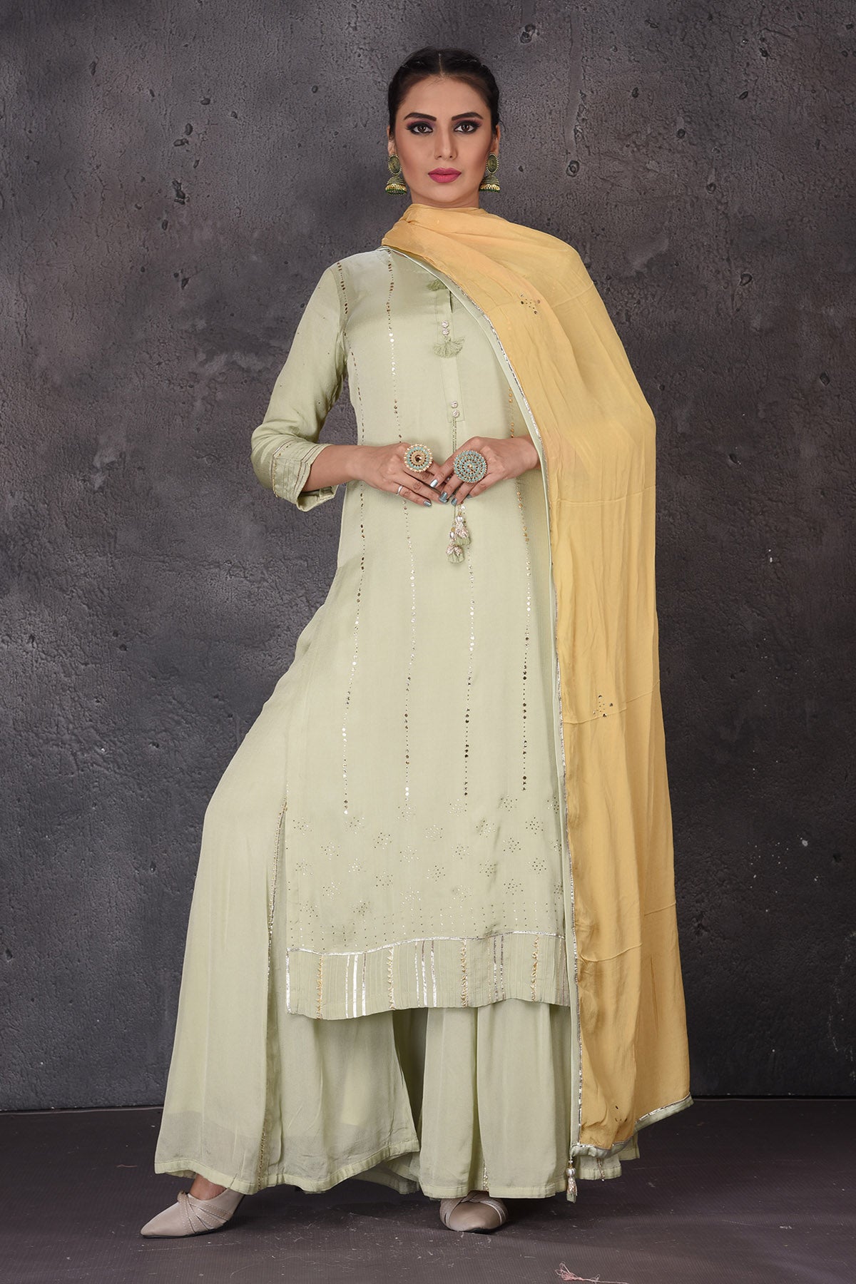 Shop beautiful pista green embellished palazzo suit online in USA with yellow dupatta. Look elegant at weddings and festive occasions in exclusive designer suits, designer gowns, Anarkali suits, sharara suits, wedding gowns, palazzo suits, designer lehenga from Pure Elegance Indian clothing store in USA.-full view