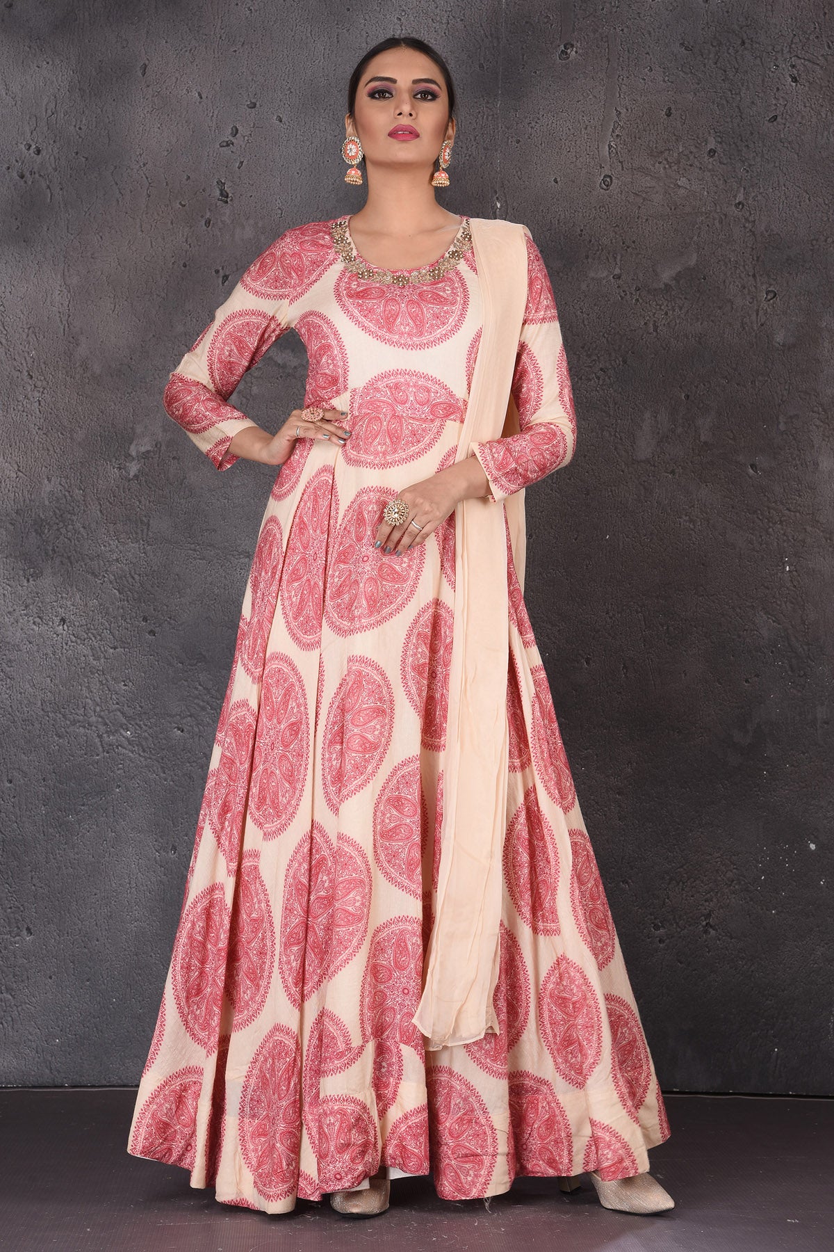 Shop stunning cream printed embroidered floorlength Anarkali online in USA with dupatta. Look elegant at weddings and festive occasions in exclusive designer suits, designer gowns, Anarkali suits, sharara suits, wedding gowns, palazzo suits, designer lehenga from Pure Elegance Indian clothing store in USA.-front