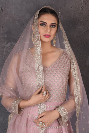 Buy stunning mauve pink embroidered Anarkali suit online in USA with dupatta. Look elegant at weddings and festive occasions in exclusive designer suits, designer gowns, Anarkali suits, sharara suits, wedding gowns, palazzo suits, designer lehenga from Pure Elegance Indian clothing store in USA.-closeup