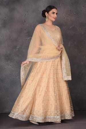 Shop beautiful peach embroidered net Anarkali suit online in USA with dupatta. Look elegant at weddings and festive occasions in exclusive designer suits, designer gowns, Anarkali suits, sharara suits, wedding gowns, palazzo suits, designer lehenga from Pure Elegance Indian clothing store in USA.-side