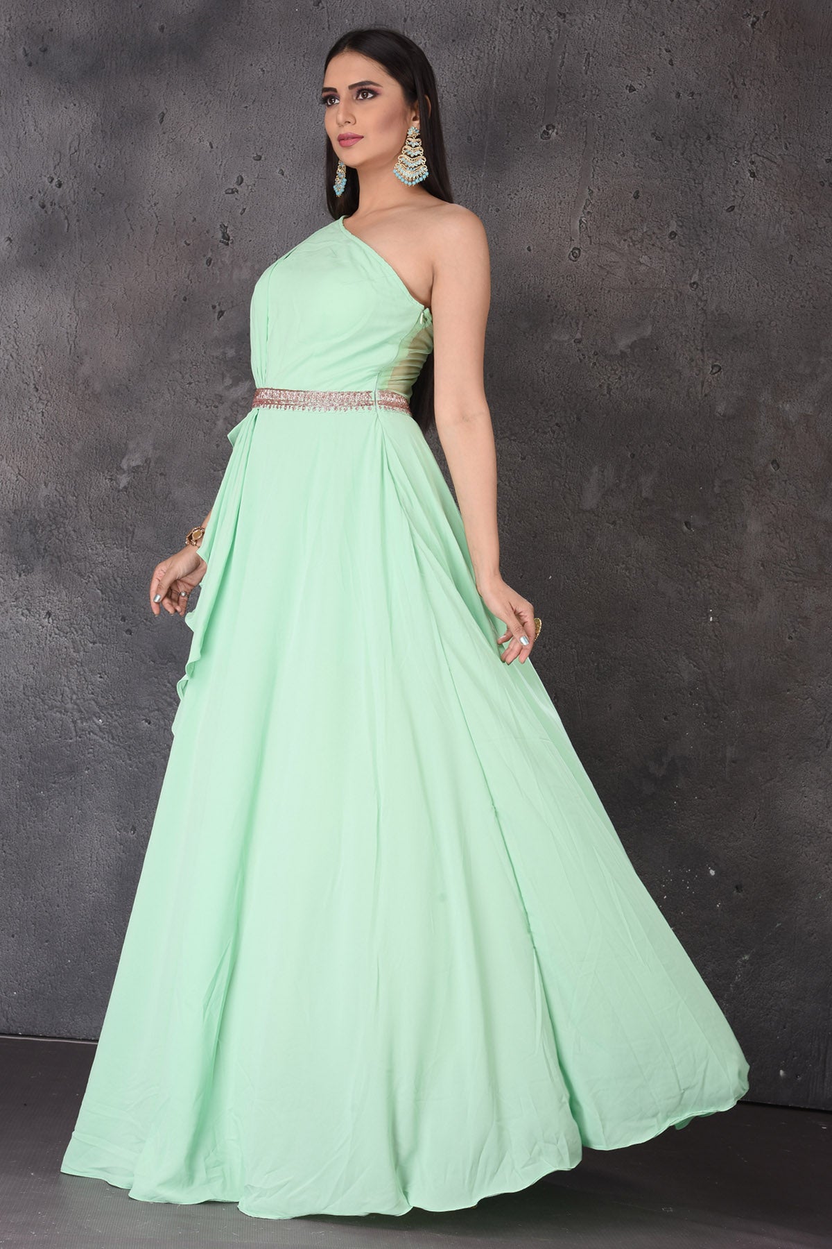 Buy stunning mint green one shoulder designer gown online in USA. Look elegant at weddings and festive occasions in exclusive designer suits, designer gowns, Anarkali suits, sharara suits, wedding gowns, palazzo suits, designer lehenga from Pure Elegance Indian clothing store in USA.-side