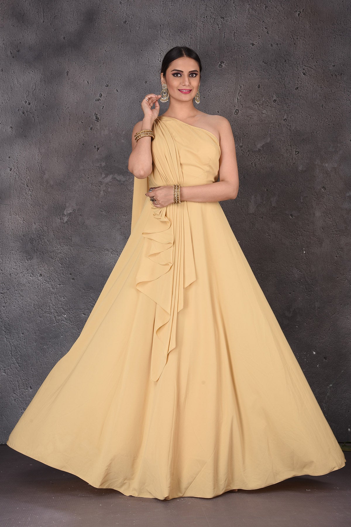 Shop gorgeous yellow one shoulder designer gown online in USA. Look elegant at weddings and festive occasions in exclusive designer suits, designer gowns, Anarkali suits, sharara suits, wedding gowns, palazzo suits, designer lehenga from Pure Elegance Indian clothing store in USA.-full view