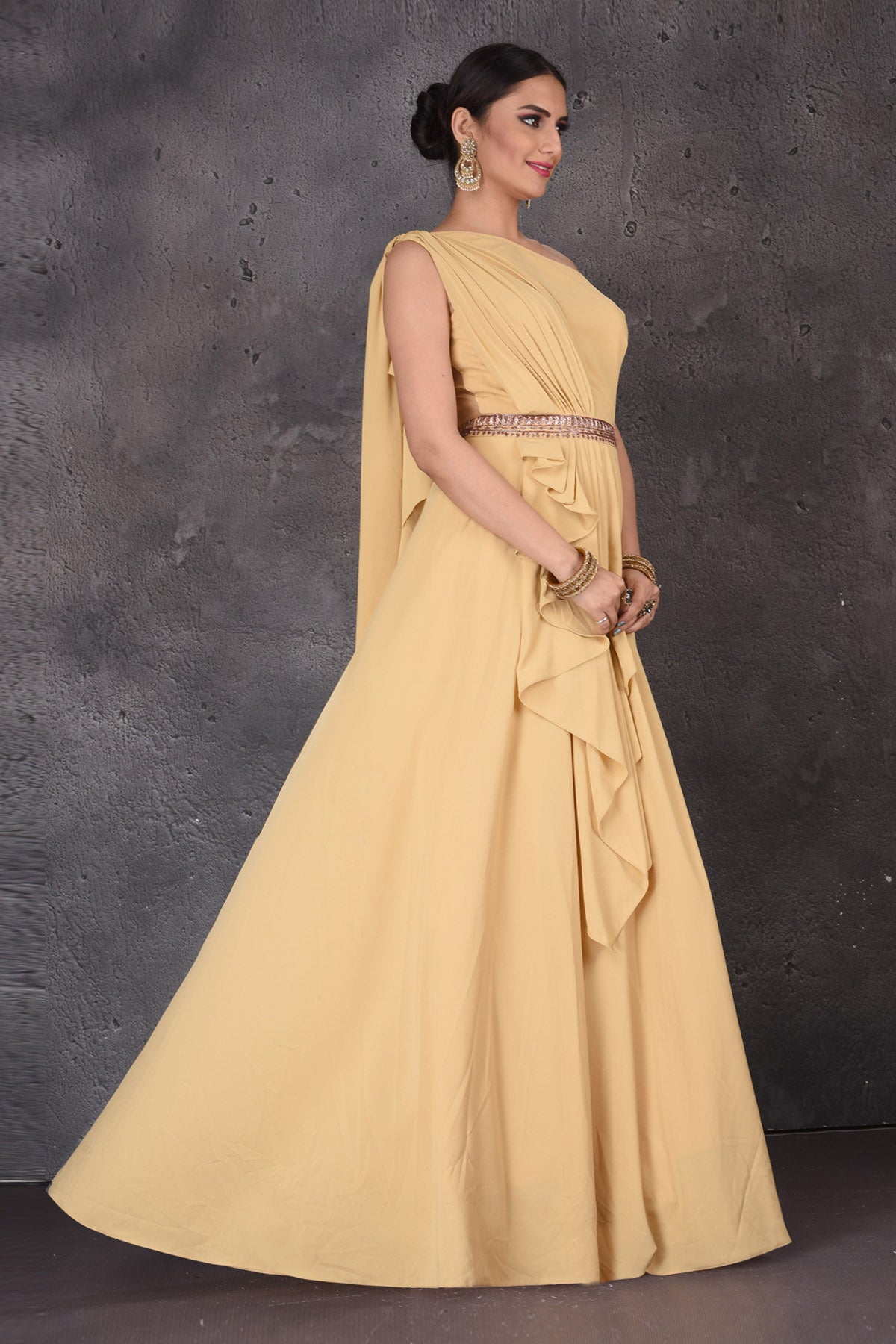 Shop gorgeous yellow one shoulder designer gown online in USA. Look elegant at weddings and festive occasions in exclusive designer suits, designer gowns, Anarkali suits, sharara suits, wedding gowns, palazzo suits, designer lehenga from Pure Elegance Indian clothing store in USA.-side