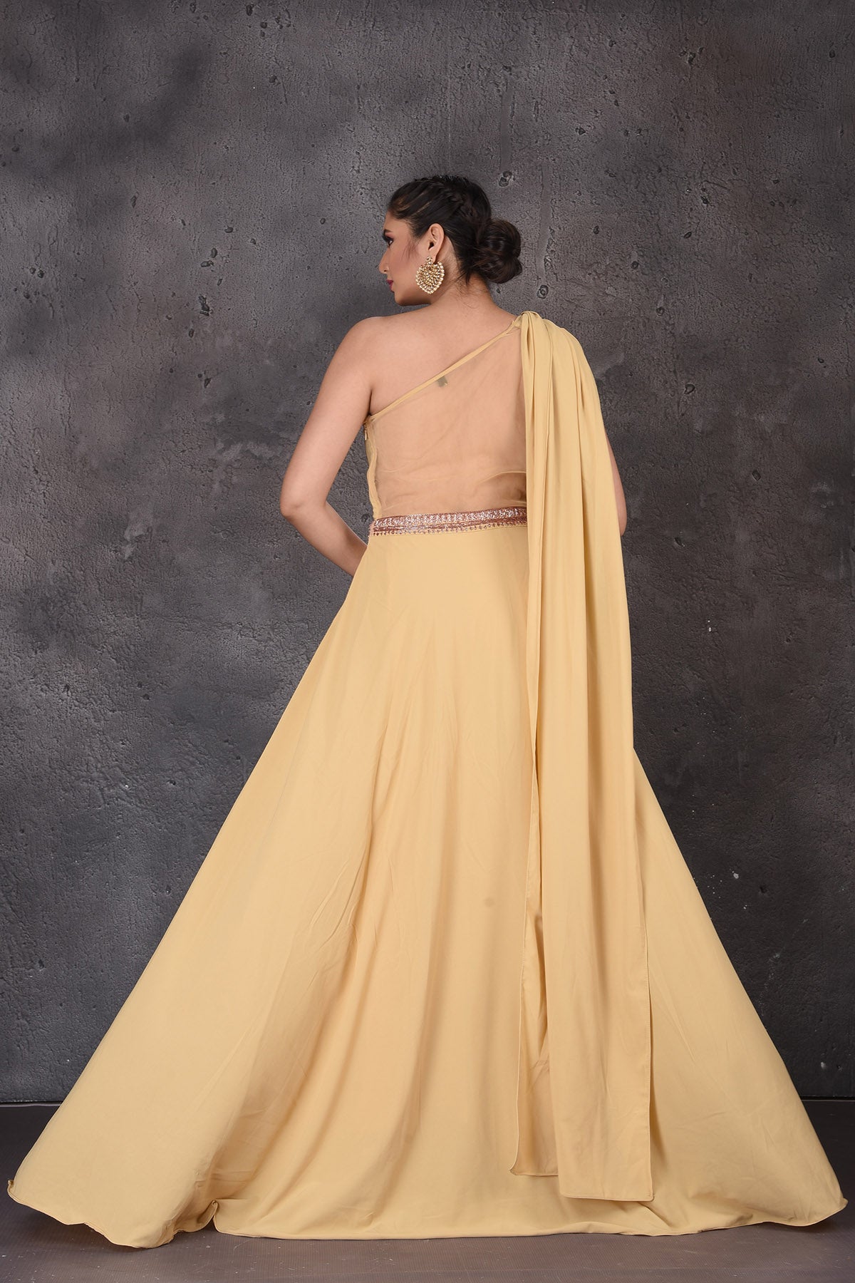Buy gorgeous mellow yellow one shoulder designer gown online in USA. Look elegant at weddings and festive occasions in exclusive designer suits, designer gowns, Anarkali suits, sharara suits, wedding gowns, palazzo suits, designer lehenga from Pure Elegance Indian clothing store in USA.-back