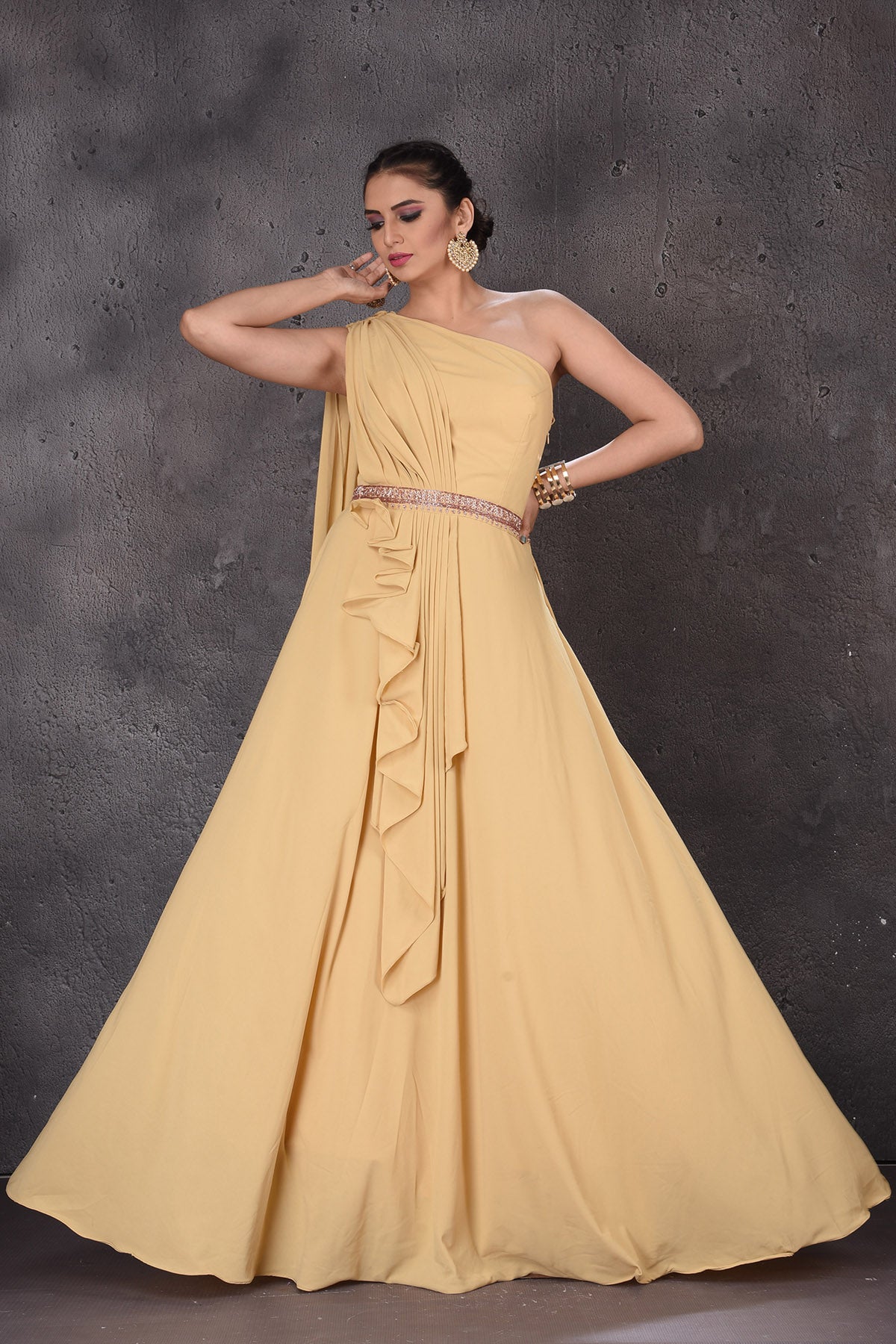 Buy gorgeous mellow yellow one shoulder designer gown online in USA. Look elegant at weddings and festive occasions in exclusive designer suits, designer gowns, Anarkali suits, sharara suits, wedding gowns, palazzo suits, designer lehenga from Pure Elegance Indian clothing store in USA.-full view