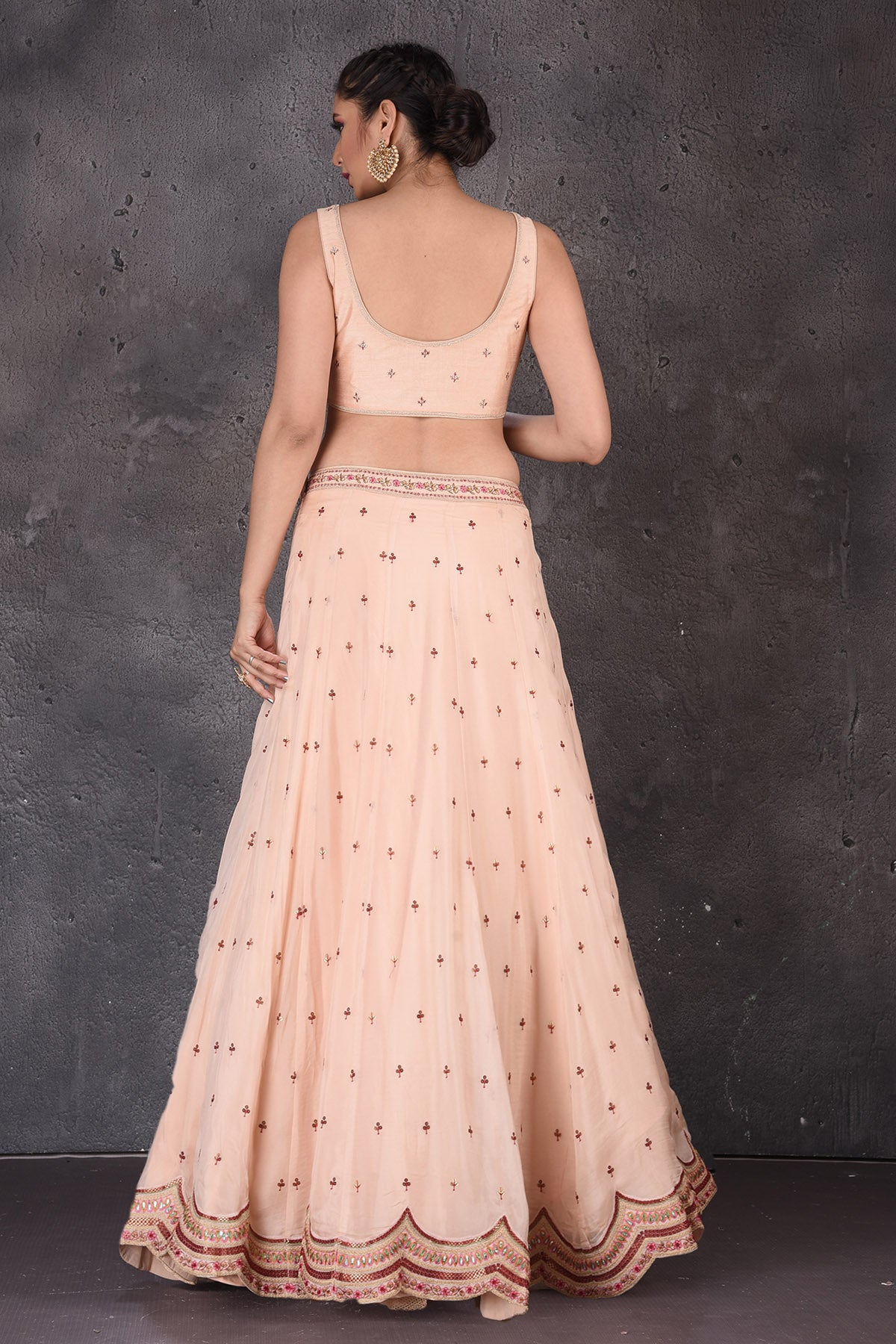Buy stunning powder pink embroidered designer lehenga online in USA with cape dupatta. Look elegant at weddings and festive occasions in exclusive designer suits, designer gowns, Anarkali suits, sharara suits, wedding gowns, palazzo suits, designer lehenga from Pure Elegance Indian clothing store in USA.-blouse back