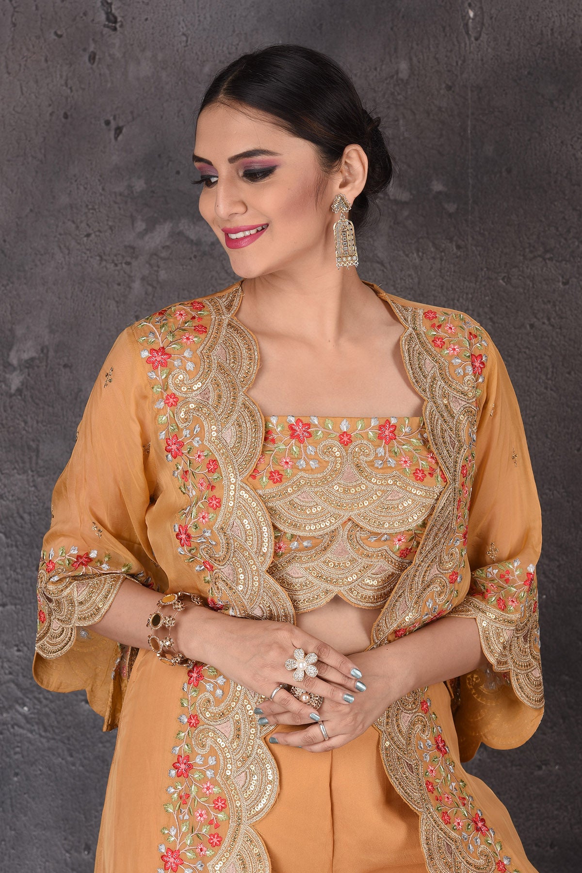 Buy stunning yellow embroidered crop top online in USA with palazzo and shrug. Look elegant at weddings and festive occasions in exclusive designer suits, designer gowns, Anarkali suits, sharara suits, wedding gowns, palazzo suits, designer lehenga from Pure Elegance Indian clothing store in USA.-closeup