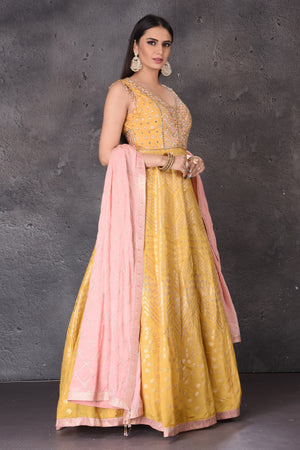 Buy stunning yellow embroidered  Anarkali suit online in USA with pink dupatta. Look elegant at weddings and festive occasions in exclusive designer suits, designer gowns, Anarkali suits, sharara suits, wedding gowns, palazzo suits, designer lehenga from Pure Elegance Indian clothing store in USA.-side