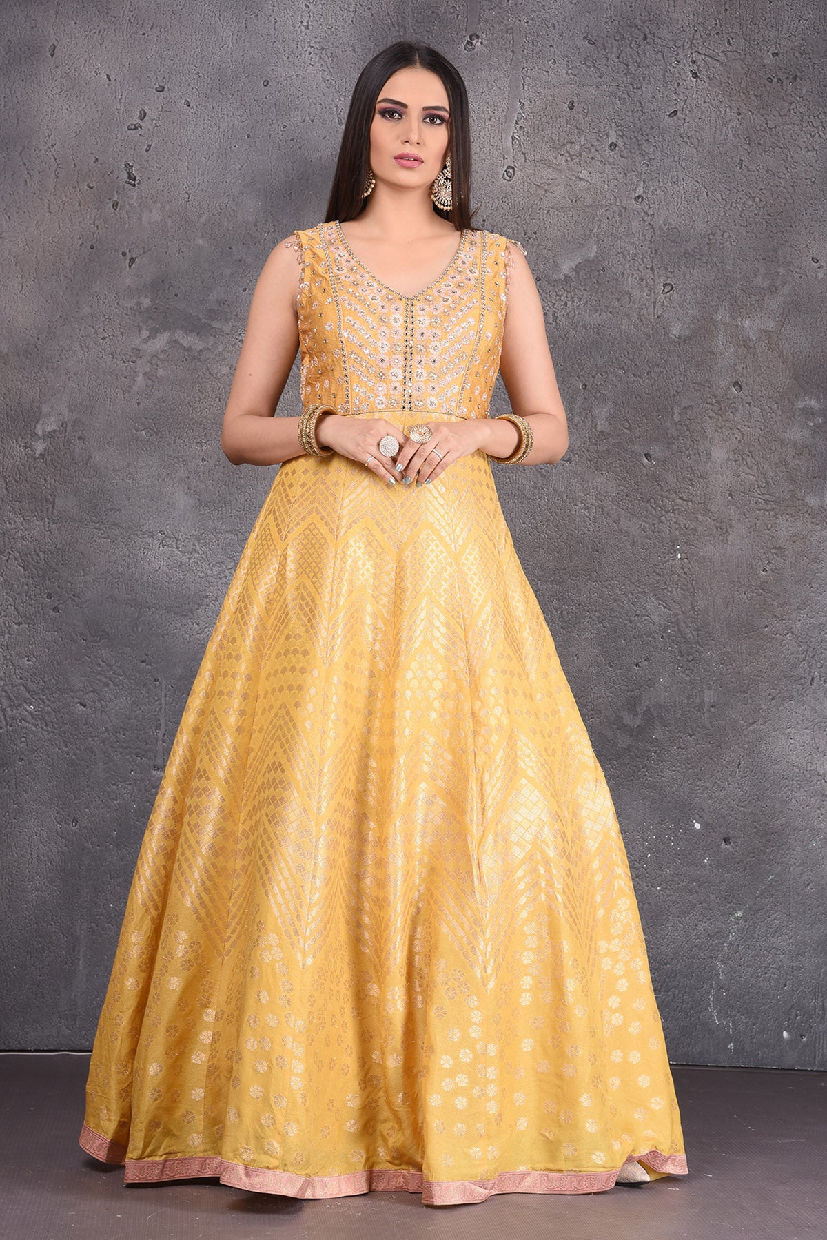 Buy stunning yellow embroidered  Anarkali suit online in USA with pink dupatta. Look elegant at weddings and festive occasions in exclusive designer suits, designer gowns, Anarkali suits, sharara suits, wedding gowns, palazzo suits, designer lehenga from Pure Elegance Indian clothing store in USA.-front