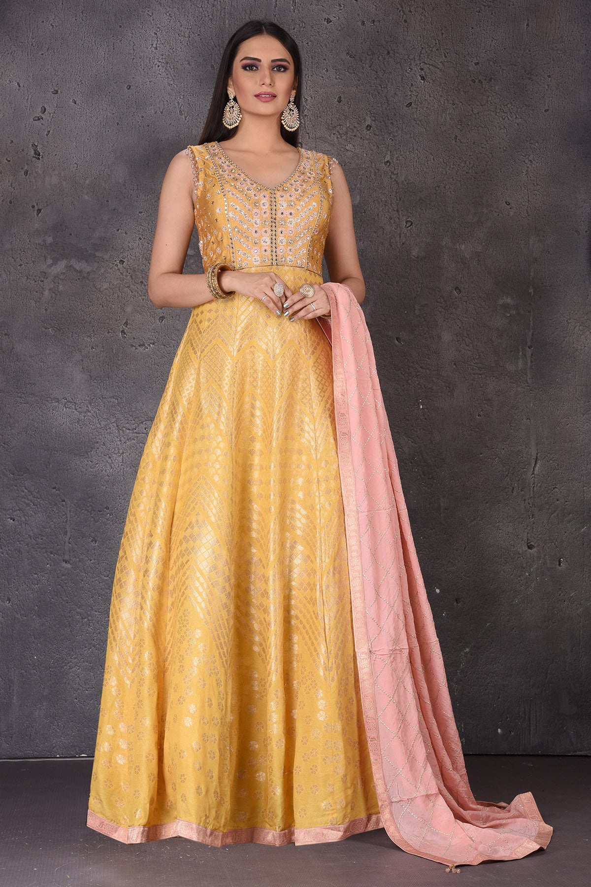 Buy stunning yellow embroidered  Anarkali suit online in USA with pink dupatta. Look elegant at weddings and festive occasions in exclusive designer suits, designer gowns, Anarkali suits, sharara suits, wedding gowns, palazzo suits, designer lehenga from Pure Elegance Indian clothing store in USA.-full view