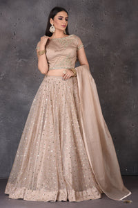 Buy stunning beige embroidered  designer lehenga online in USA with dupatta. Look elegant at weddings and festive occasions in exclusive designer suits, designer gowns, Anarkali suits, sharara suits, wedding gowns, palazzo suits, designer lehenga from Pure Elegance Indian clothing store in USA.-full view