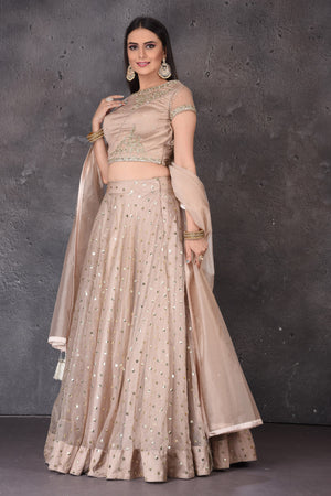 Buy stunning beige embroidered  designer lehenga online in USA with dupatta. Look elegant at weddings and festive occasions in exclusive designer suits, designer gowns, Anarkali suits, sharara suits, wedding gowns, palazzo suits, designer lehenga from Pure Elegance Indian clothing store in USA.-side