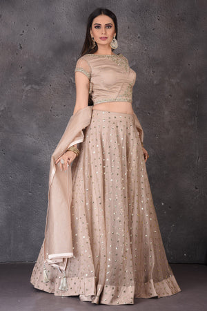 Buy stunning beige embroidered  designer lehenga online in USA with dupatta. Look elegant at weddings and festive occasions in exclusive designer suits, designer gowns, Anarkali suits, sharara suits, wedding gowns, palazzo suits, designer lehenga from Pure Elegance Indian clothing store in USA.-right