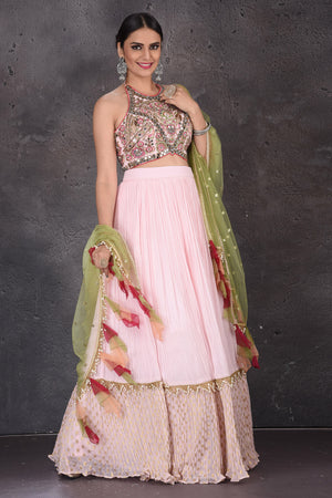 Buy elegant powder pink embroidered lehenga online in USA with green dupatta. Look elegant at weddings and festive occasions in exclusive designer suits, designer gowns, Anarkali suits, sharara suits, wedding gowns, palazzo suits, designer lehenga from Pure Elegance Indian clothing store in USA.-side
