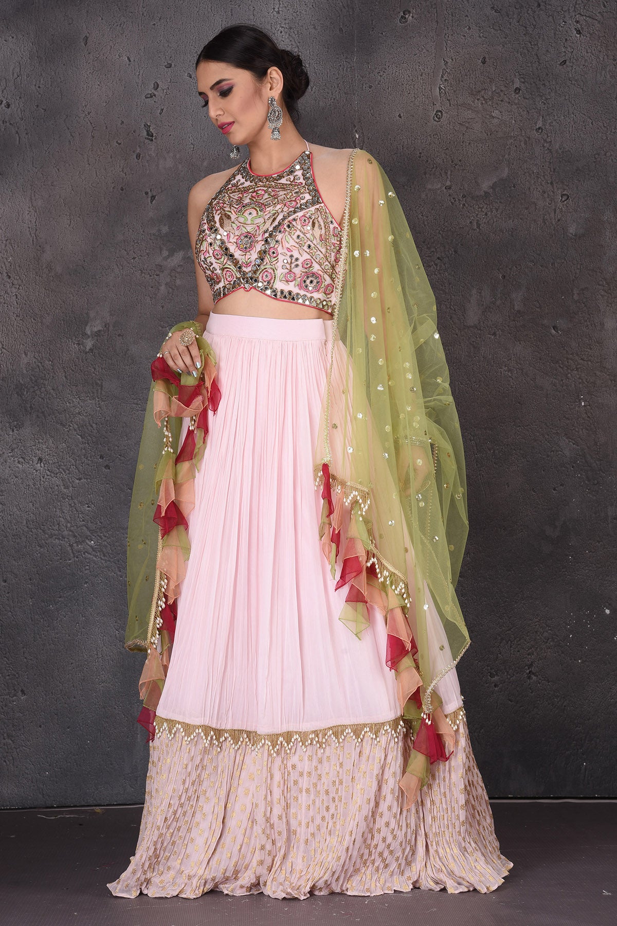Buy elegant powder pink embroidered lehenga online in USA with green dupatta. Look elegant at weddings and festive occasions in exclusive designer suits, designer gowns, Anarkali suits, sharara suits, wedding gowns, palazzo suits, designer lehenga from Pure Elegance Indian clothing store in USA.-front