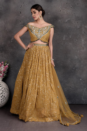 Buy stunning mustard embroidered off-shoulder lehenga online in USA. Set a fashion statement at parties in designer dresses, Anarkali suits, designer lehengas, gowns, Indowestern dresses from Pure Elegance Indian fashion store in USA.-front
