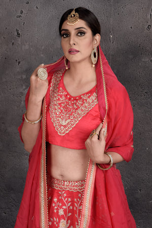 Buy tomato red embroidered designer lehenga online in USA with dupatta. Set a fashion statement at parties in designer dresses, Anarkali suits, designer lehengas, gowns, Indowestern dresses from Pure Elegance Indian fashion store in USA.-closeup