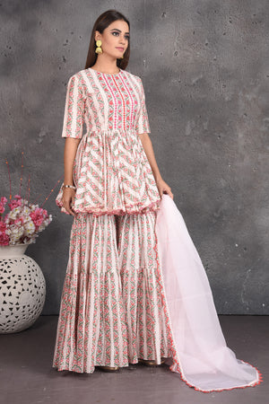 Buy cream printed peplum sharara suit online in USA with dupatta. Set a fashion statement at parties in designer dresses, Anarkali suits, designer lehengas, gowns, Indowestern dresses from Pure Elegance Indian fashion store in USA.-right