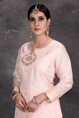 Shop beautiful powder pink embroidered sharara suit online in USA with dupatta. Set a fashion statement at parties in designer Indian dresses, Anarkali suits, designer lehengas, gowns, Indowestern dresses from Pure Elegance Indian fashion store in USA.-closeup