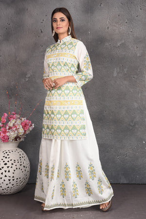 Shop elegant off-white printed skirt set online in USA. Set a fashion statement at parties in designer dresses, Anarkali suits, designer lehengas, gowns, Indowestern dresses from Pure Elegance Indian fashion store in USA.-left