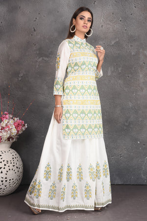 Shop elegant off-white printed skirt set online in USA. Set a fashion statement at parties in designer dresses, Anarkali suits, designer lehengas, gowns, Indowestern dresses from Pure Elegance Indian fashion store in USA.-right