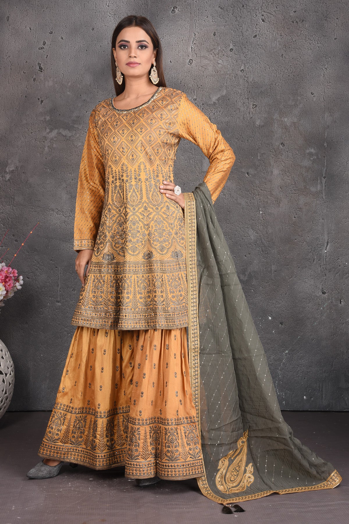 Buy stunning yellow embroidered sharara suit online in USA with grey dupatta. Set a fashion statement at parties in designer dresses, Anarkali suits, designer lehengas, gowns, Indowestern dresses from Pure Elegance Indian fashion store in USA.-front