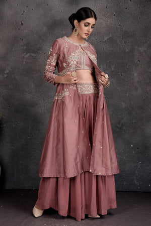 Buy stunning dusty pink embroidered skirt set online in USA with shrug. Set a fashion statement at parties in designer Indian suits, Anarkali suits, designer lehengas, gowns, Indowestern dresses from Pure Elegance Indian fashion store in USA.-side