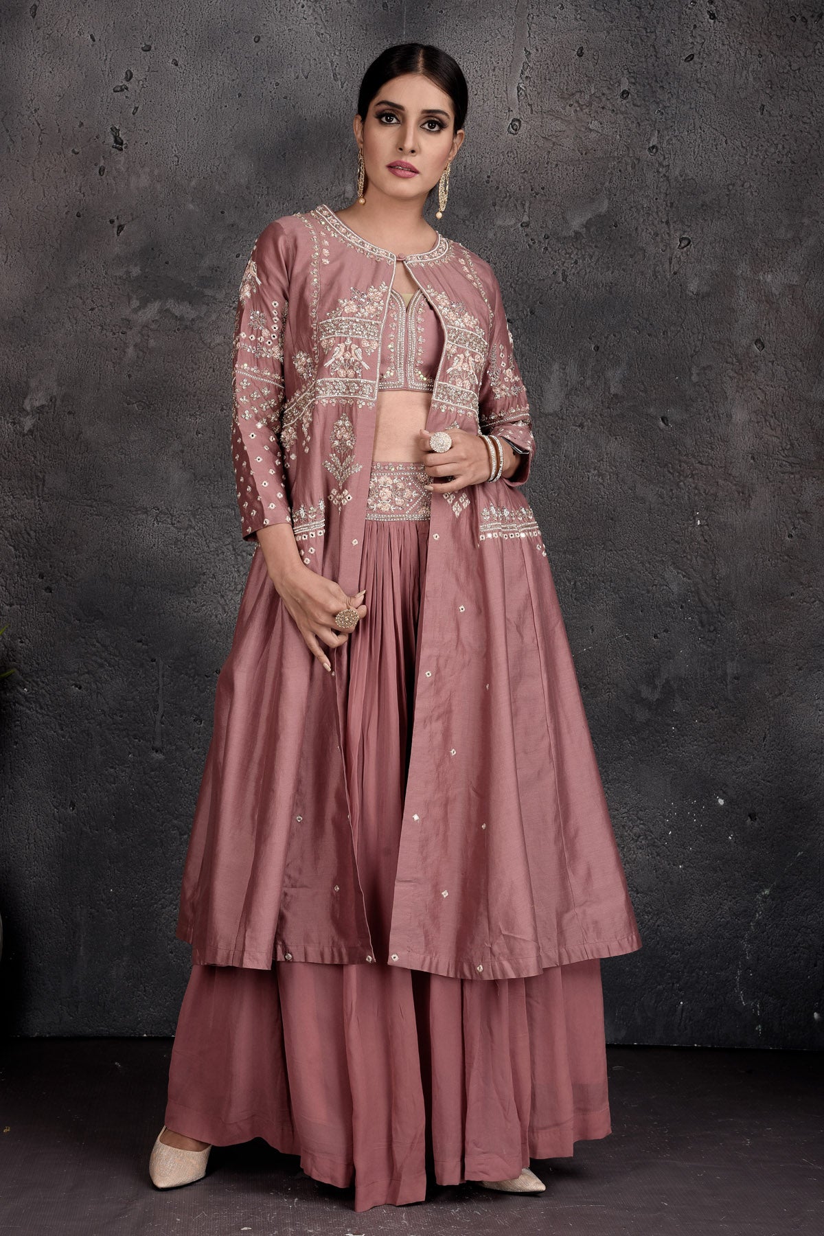 Buy stunning dusty pink embroidered skirt set online in USA with shrug. Set a fashion statement at parties in designer Indian suits, Anarkali suits, designer lehengas, gowns, Indowestern dresses from Pure Elegance Indian fashion store in USA.-jacket