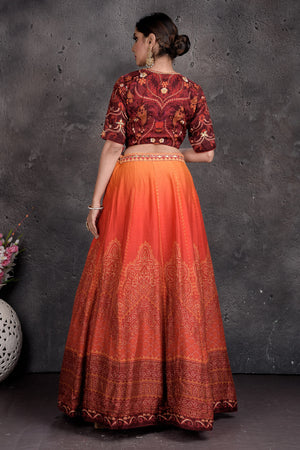 Buy maroon and orange printed and embroidered lehenga online in USA with dupatta. Set a fashion statement at parties in designer Indian suits, Anarkali suits, designer lehengas, gowns, Indowestern dresses from Pure Elegance Indian fashion store in USA.-back