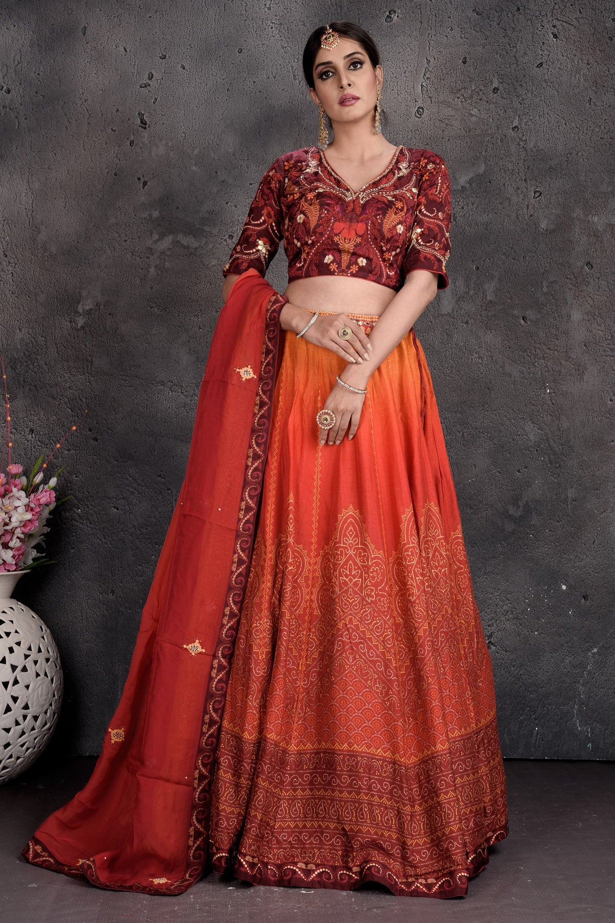 Buy maroon and orange printed and embroidered lehenga online in USA with dupatta. Set a fashion statement at parties in designer Indian suits, Anarkali suits, designer lehengas, gowns, Indowestern dresses from Pure Elegance Indian fashion store in USA.-full view