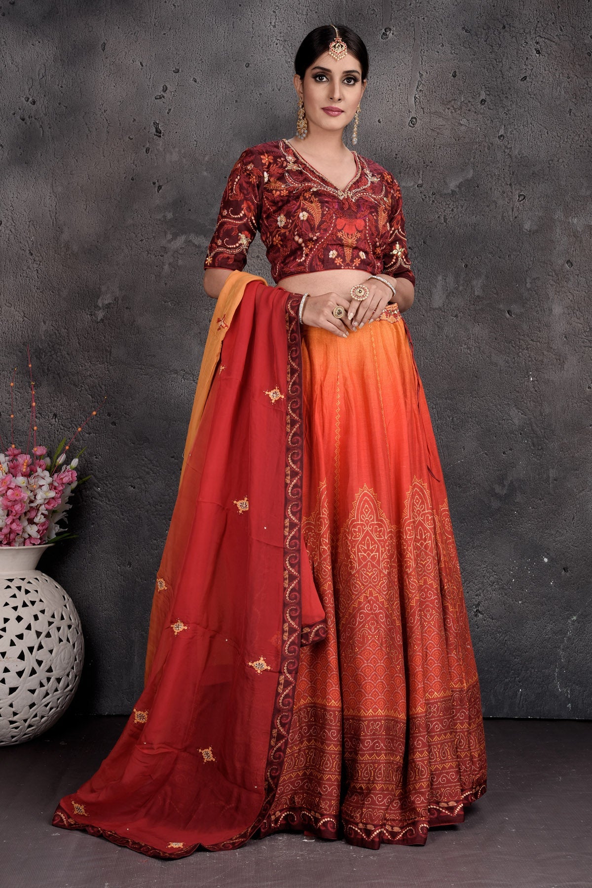 Buy maroon and orange printed and embroidered lehenga online in USA with dupatta. Set a fashion statement at parties in designer Indian suits, Anarkali suits, designer lehengas, gowns, Indowestern dresses from Pure Elegance Indian fashion store in USA.-side