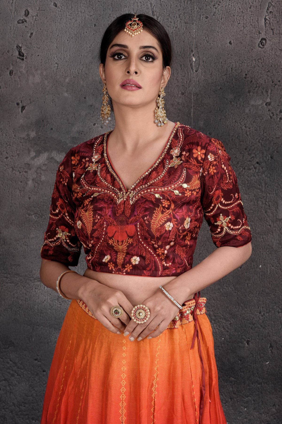 Buy maroon and orange printed and embroidered lehenga online in USA with dupatta. Set a fashion statement at parties in designer Indian suits, Anarkali suits, designer lehengas, gowns, Indowestern dresses from Pure Elegance Indian fashion store in USA.-closeup