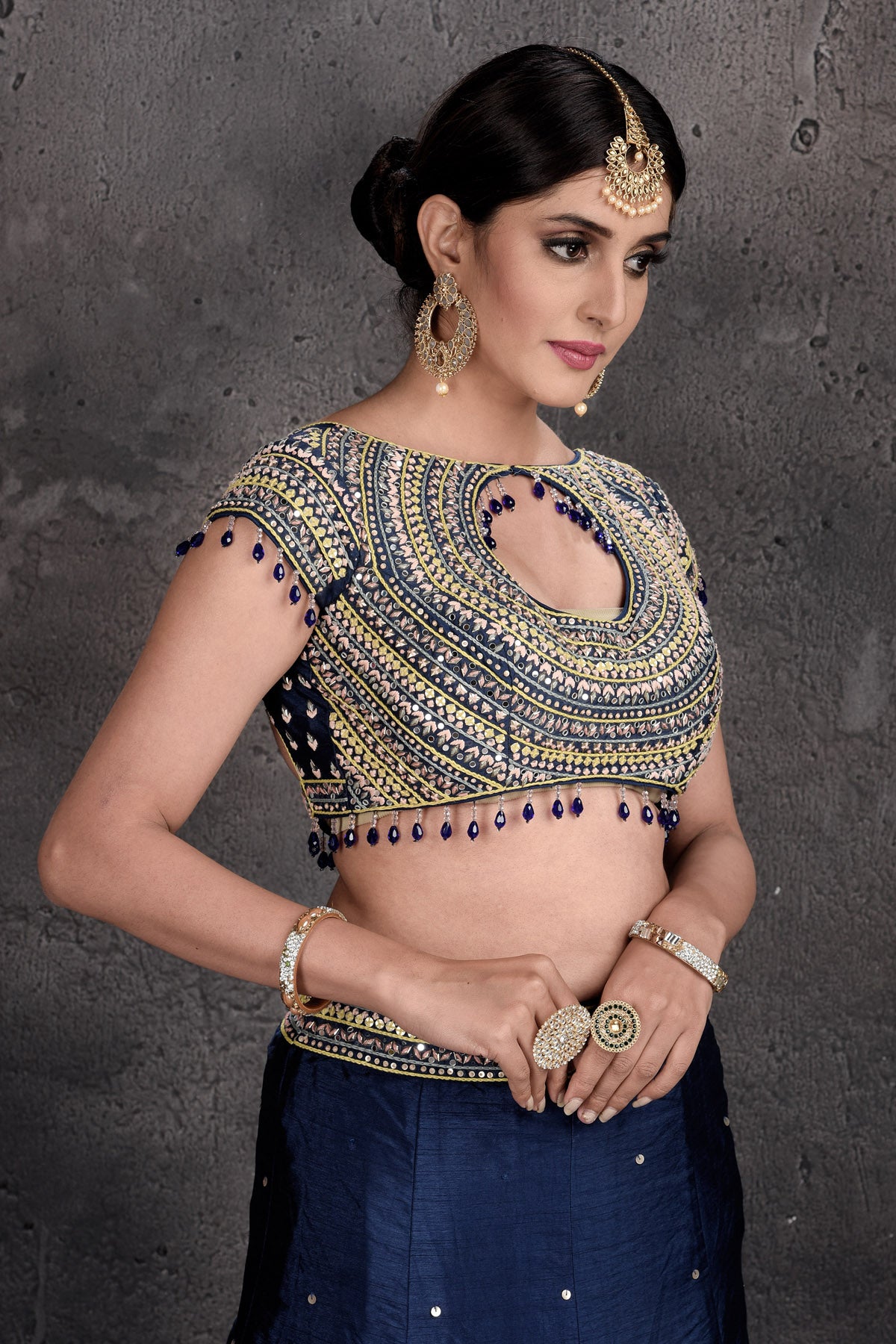 Buy stunning dark blue and embroidered designer lehenga online in USA with dupatta. Set a fashion statement at parties in designer Indian suits, Anarkali suits, designer lehengas, gowns, Indowestern dresses from Pure Elegance Indian fashion store in USA.-closeup