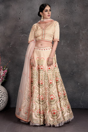 Buy stunning off-white floral embroidered lehenga online in USA with dupatta. Set a fashion statement at parties in designer Indian suits, Anarkali suits, designer lehengas, gowns, Indowestern dresses from Pure Elegance Indian fashion store in USA.-front