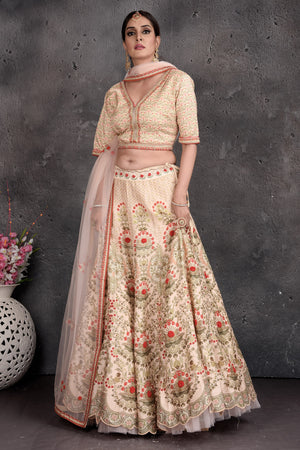 Buy stunning off-white floral embroidered lehenga online in USA with dupatta. Set a fashion statement at parties in designer Indian suits, Anarkali suits, designer lehengas, gowns, Indowestern dresses from Pure Elegance Indian fashion store in USA.-side