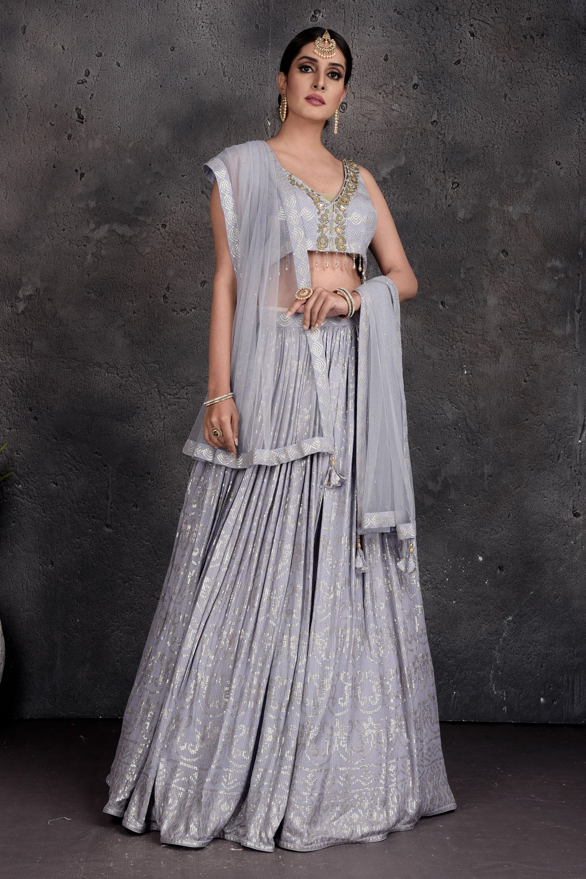 Buy beautiful light grey embroidered designer lehenga online in USA with dupatta. Set a fashion statement at parties in designer Indian suits, Anarkali suits, designer lehengas, gowns, Indowestern dresses from Pure Elegance Indian fashion store in USA.-side