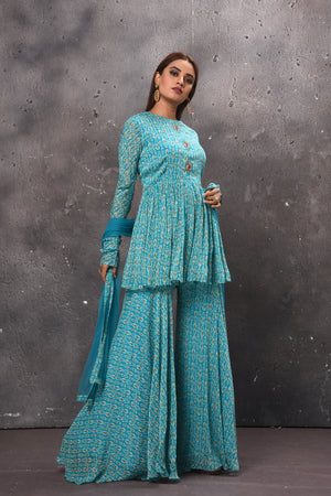 Buy stunning light blue gharara suit online in USA with matching dupatta. Get set for weddings and festive occasions in exclusive designer Anarkali suits, wedding gown, salwar suits, gharara suits, Indowestern dresses from Pure Elegance Indian fashion store in USA.-right