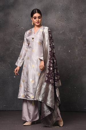 Shop stunning light grey palazzo suit online in USA with Banarasi dupatta. Get set for weddings and festive occasions in exclusive designer Anarkali suits, wedding gown, salwar suits, gharara suits, Indowestern dresses from Pure Elegance Indian fashion store in USA.-side