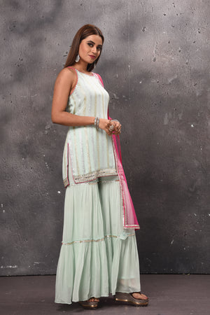 Shop beautiful mint green embellished sharara suit online in USA with pink dupatta. Get set for weddings and festive occasions in exclusive designer Anarkali suits, wedding gown, salwar suits, gharara suits, Indowestern dresses from Pure Elegance Indian fashion store in USA.-right