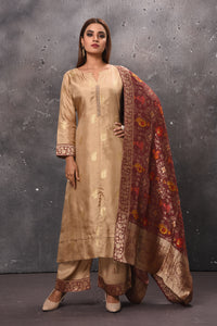 Shop beautiful beige palazzo suit online in USA with red Banarasi dupatta. Get set for weddings and festive occasions in exclusive designer Anarkali suits, wedding gown, salwar suits, gharara suits, Indowestern dresses from Pure Elegance Indian fashion store in USA.-full view