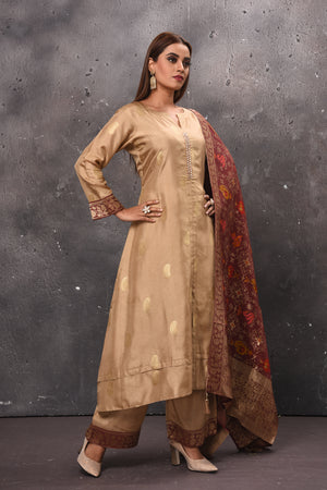 Shop beautiful beige palazzo suit online in USA with red Banarasi dupatta. Get set for weddings and festive occasions in exclusive designer Anarkali suits, wedding gown, salwar suits, gharara suits, Indowestern dresses from Pure Elegance Indian fashion store in USA.-right