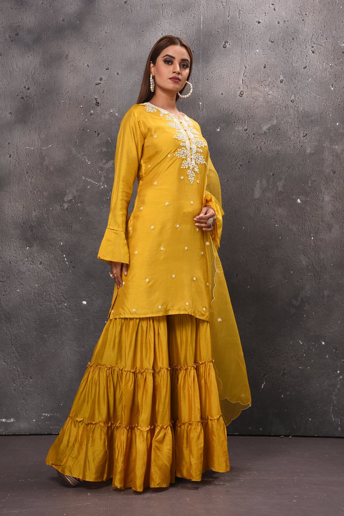 Shop beautiful yellow tiered sharara suit online in USA with dupatta. Get set for weddings and festive occasions in exclusive designer Anarkali suits, wedding gown, salwar suits, gharara suits, Indowestern dresses from Pure Elegance Indian fashion store in USA.-side