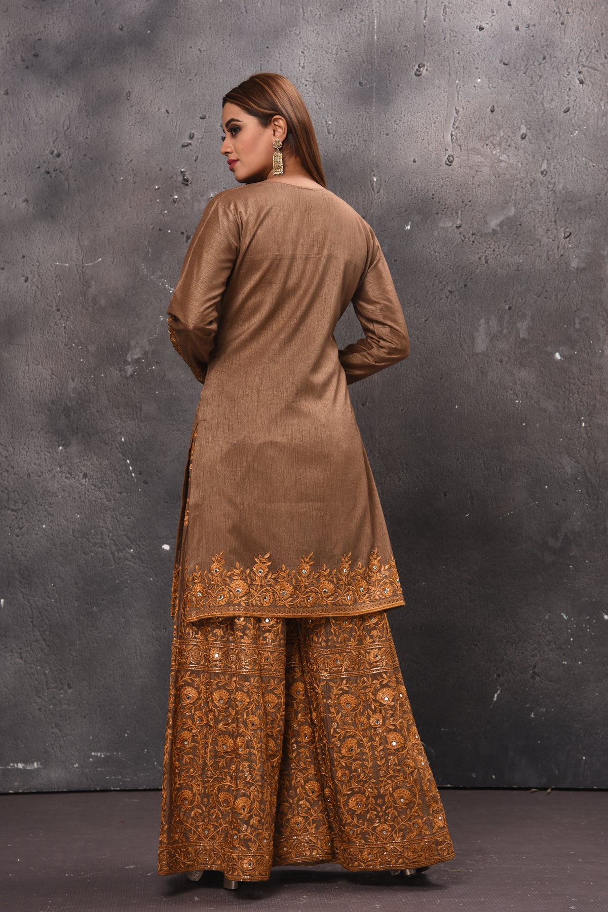 Shop stunning beige embroidered sharara suit online in USA with dupatta. Get set for weddings and festive occasions in exclusive designer Anarkali suits, wedding gown, salwar suits, gharara suits, Indowestern dresses from Pure Elegance Indian fashion store in USA.-back