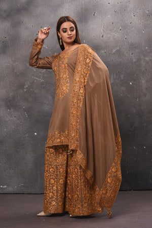 Shop stunning beige embroidered sharara suit online in USA with dupatta. Get set for weddings and festive occasions in exclusive designer Anarkali suits, wedding gown, salwar suits, gharara suits, Indowestern dresses from Pure Elegance Indian fashion store in USA.-side