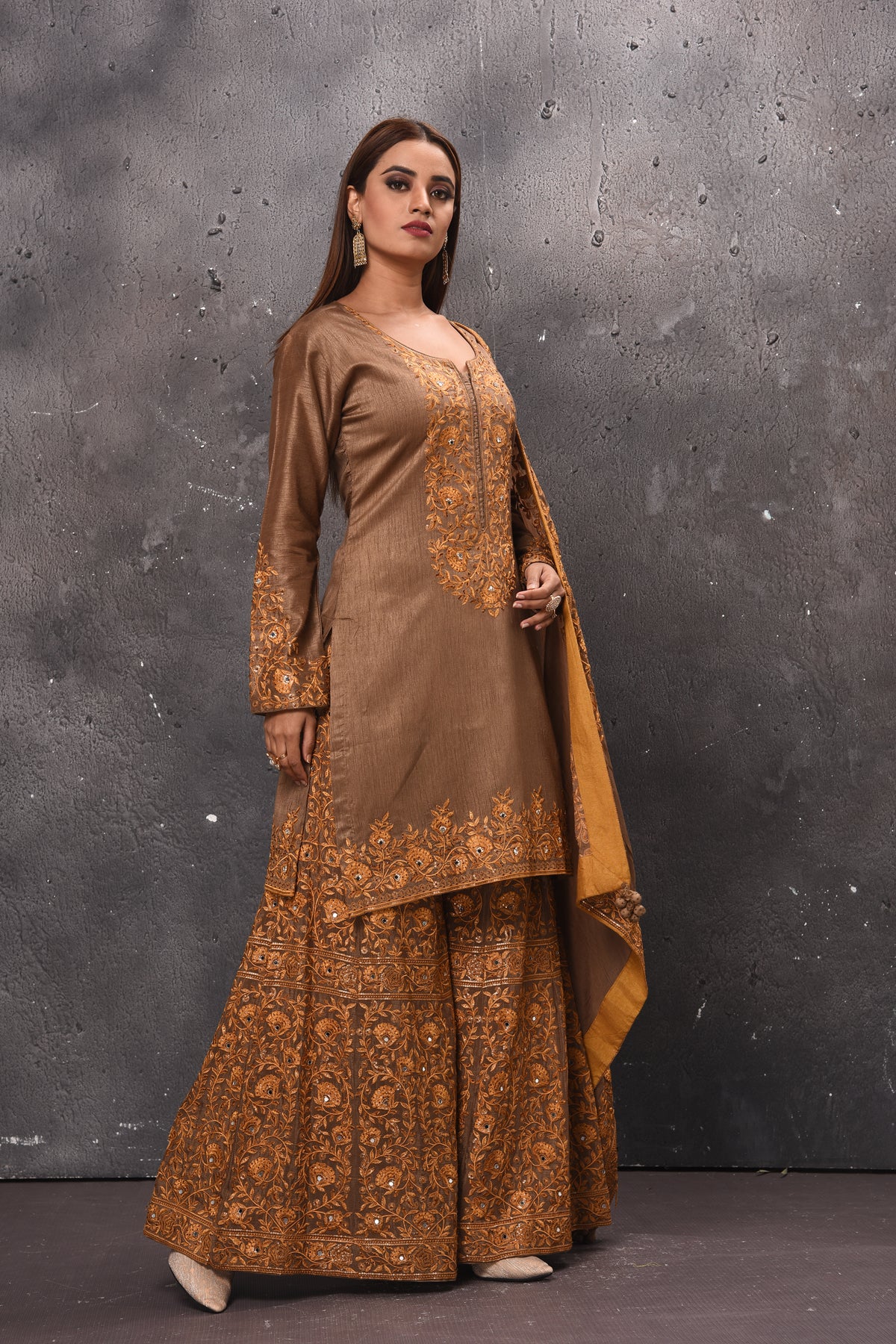 Shop stunning beige embroidered sharara suit online in USA with dupatta. Get set for weddings and festive occasions in exclusive designer Anarkali suits, wedding gown, salwar suits, gharara suits, Indowestern dresses from Pure Elegance Indian fashion store in USA.-right
