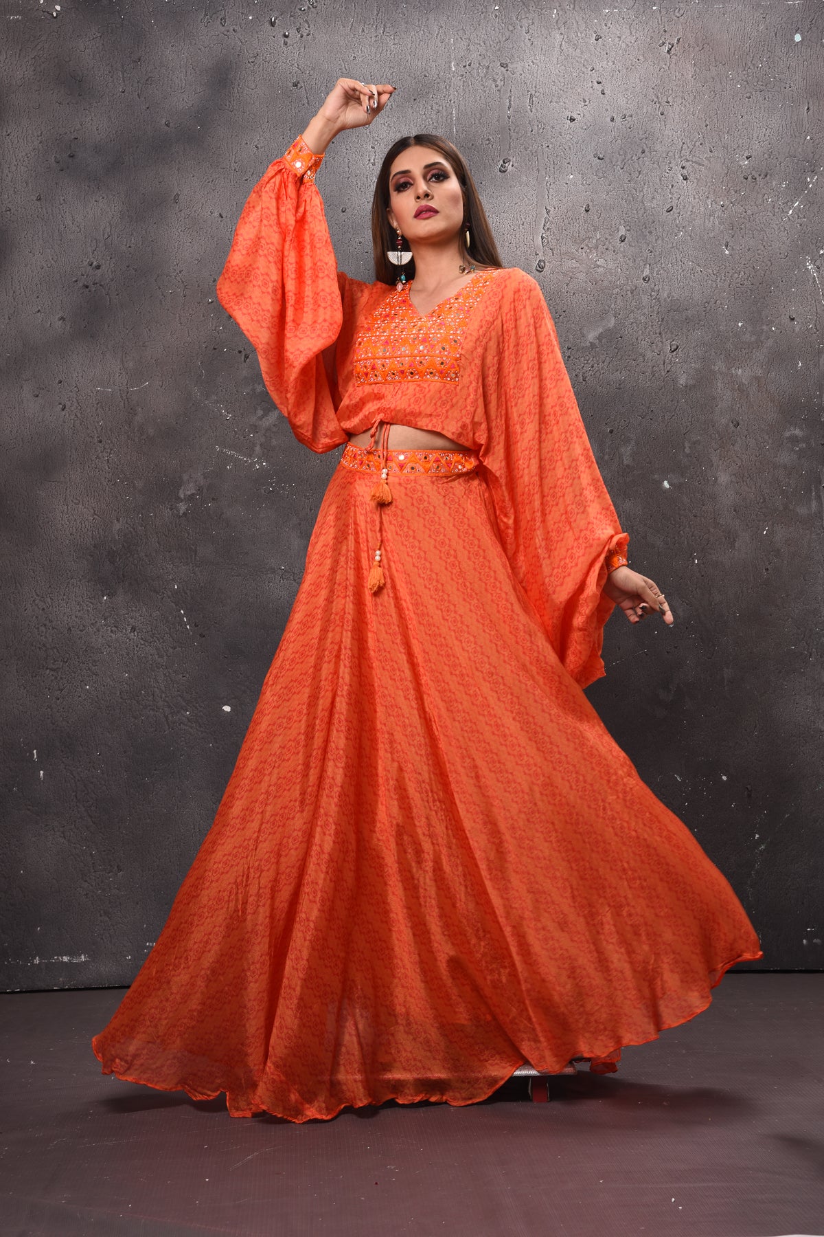 Shop beautiful orange mirror work skirt set online in USA. Get set for weddings and festive occasions in exclusive designer Anarkali suits, wedding gown, salwar suits, gharara suits, Indowestern dresses from Pure Elegance Indian fashion store in USA.-front