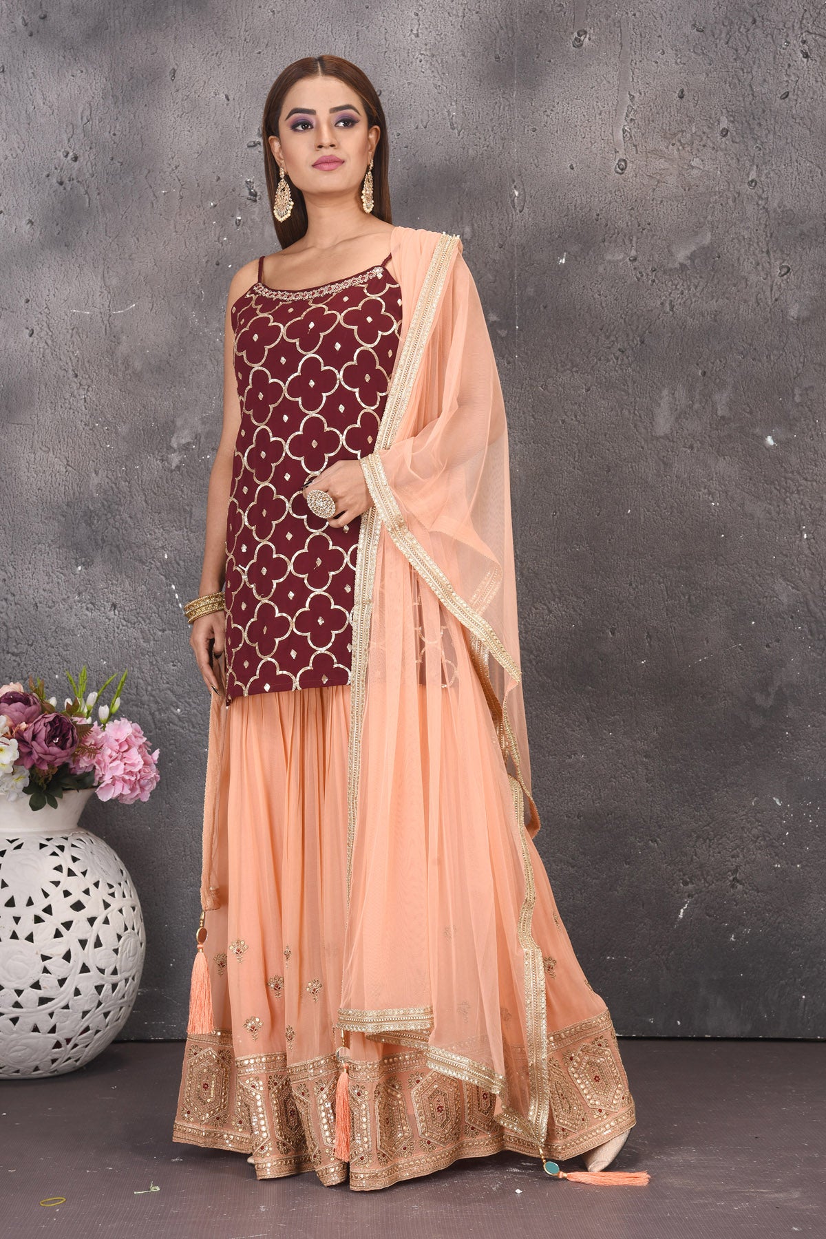 Shop gorgeous maroon and peach embroidered sharara suit online in USA with dupatta. Look stylish at parties and wedding festivities in designer dresses, Indowestern outfits, Anarkali suits, wedding lehengas, palazzo suits, sharara suits from Pure Elegance Indian clothing store in USA.-sharara
