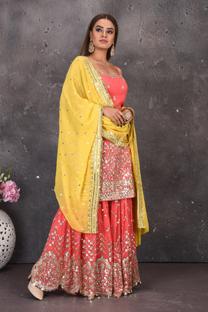 Buy stunning salmon pink mirror work sharara suit online in USA with yellow dupatta. Look stylish at parties and wedding festivities in designer dresses, Indowestern outfits, Anarkali suits, wedding lehengas, palazzo suits, sharara suits from Pure Elegance Indian clothing store in USA.-side